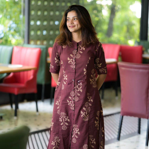 Woman wearing Cotton Suit women's premium cotton co-ord set with maroon floral print in indoor cafe