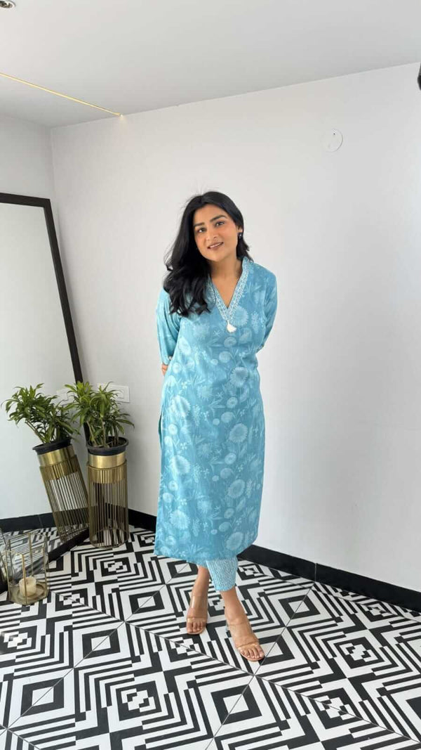 Woman wearing blue printed kurta standing on black and white geometric floor indoors