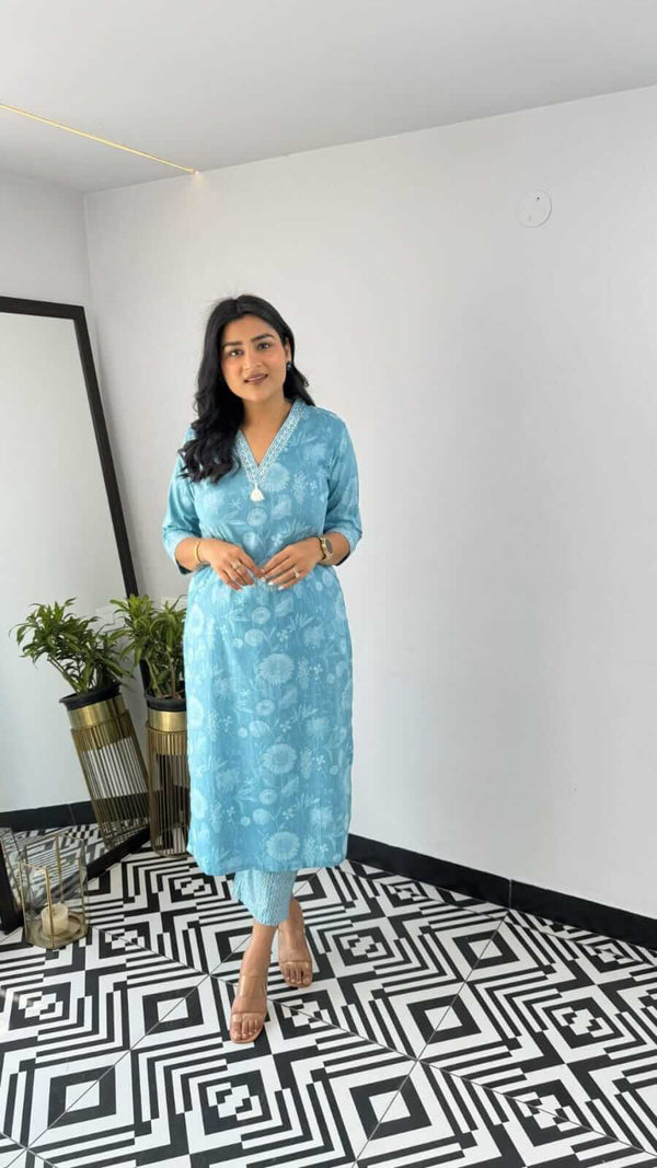 Woman wearing blue printed kurta set standing on black and white patterned floor