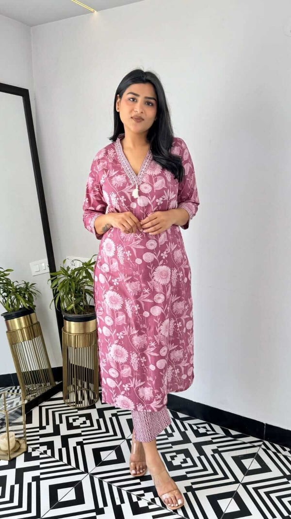 Woman wearing yellow and pink office wear kurta with floral pattern standing indoors