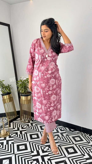 Woman wearing yellow and pink office wear kurta by Cotton Suit standing on black and white patterned floor