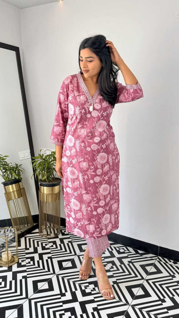 Woman wearing yellow and pink office wear kurta by Cotton Suit standing on black and white patterned floor