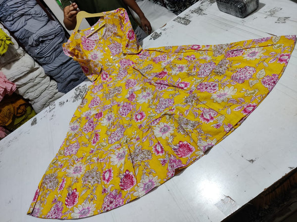  Cotton Suit yellow floral cotton dress for women spread out on a white table showing vibrant pink and white flowers